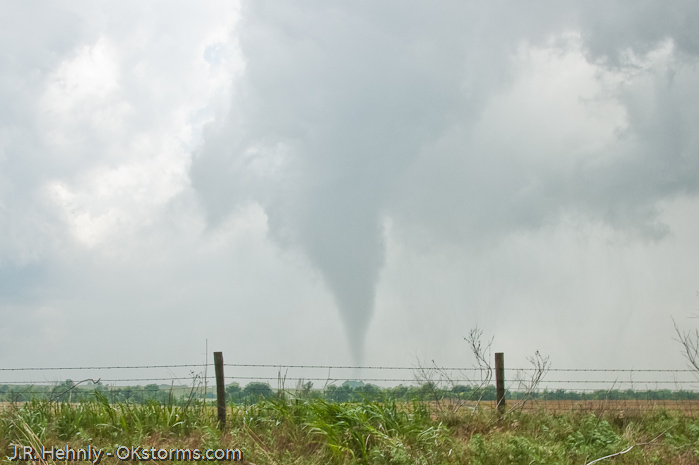 Tornado west of Bison, OK ramains on the ground for several minutes.
