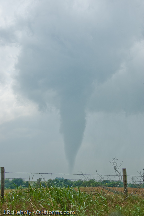 Tornado west of Bison, OK ramains on the ground for several minutes.