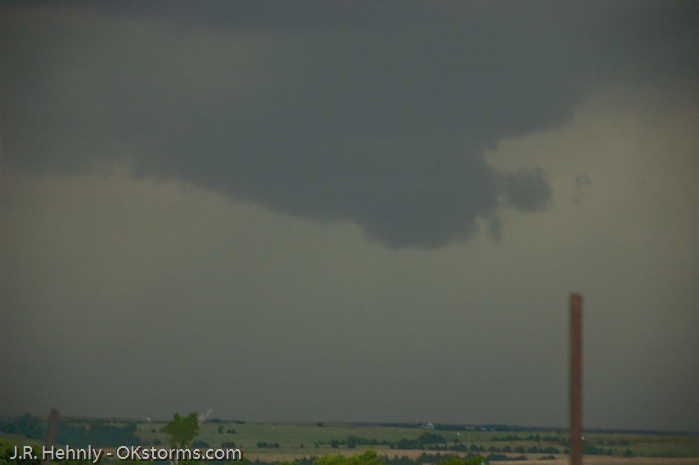 Looking west at numerous lowerings and scud clouds
