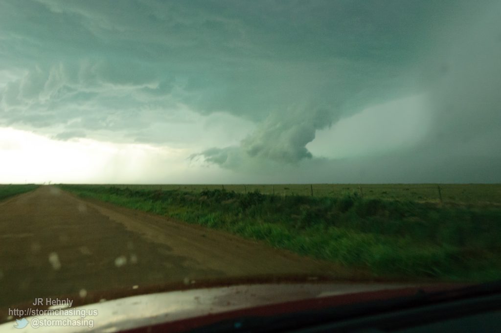 I'm racing west on my only road option, to the west past the storm, then south. I'm thinking I'm not going to make it at this point and afraid of rain turning this road to mud - 6/1/2012 5:59:02 PM - Dalhart, Texas - USA - 