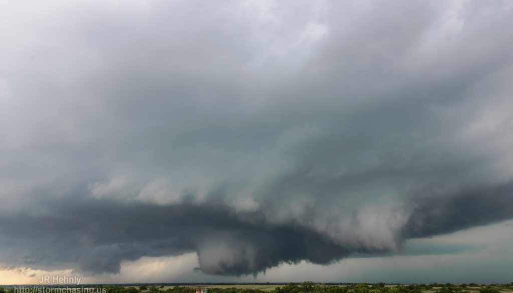 A brief tornado descends from a rapidly rotating wall cloud near Amber - 5/6/2015 4:33:55 PM - N2920 Road - Amber, Oklahoma - 