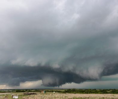 A brief tornado descends from a rapidly rotating wall cloud near Amber - 5/6/2015 4:33:55 PM - N2920 Road - Amber, Oklahoma - 